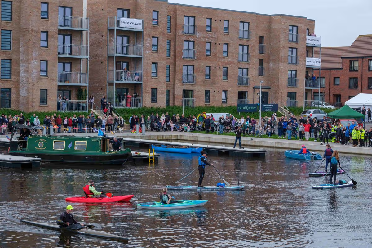 People enjoying kayaking and paddleboarding at a Winchburgh canal community event